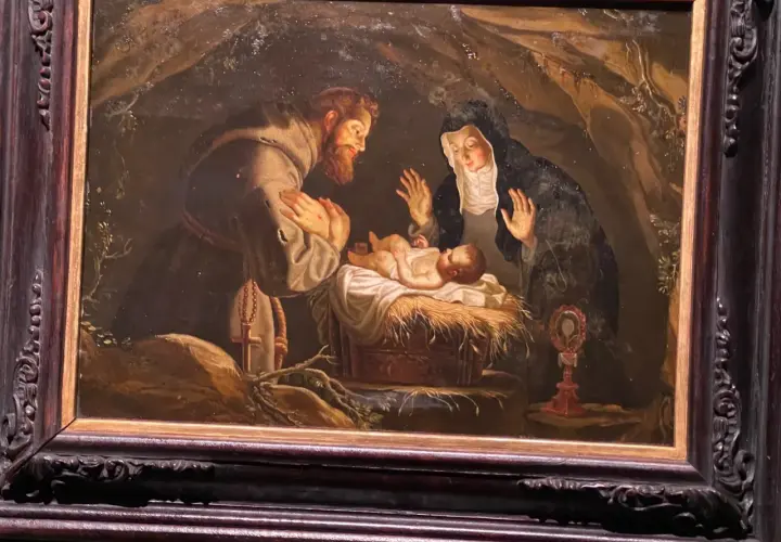 Święty Franciszek i święta Klara adorują Dzieciątko Jezus. Obraz oddaje ducha franciszkanizmu poprzez prostotę i pokorę sceny.